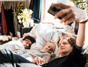 man in black t-shirt lying on bed